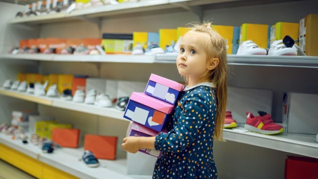 Kids picking up shoes